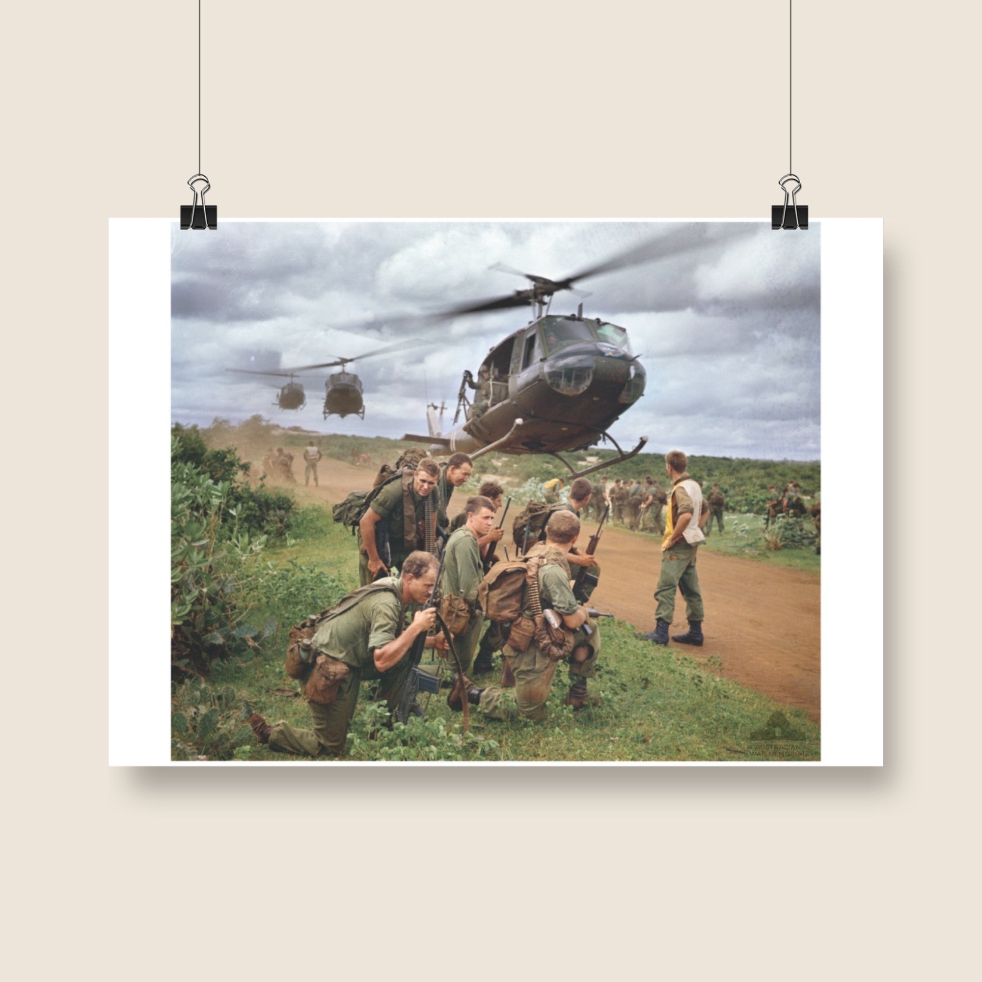 Poster mock-up of Michael Coleridge's photograph - Members of 5 Platoon, B Company, 7RAR, waiting for an Iroquois, near Lang Phuoc Hai, Vietnam. 1967. From the collection of the Australian War Memorial - EKN/67/0130/VN.