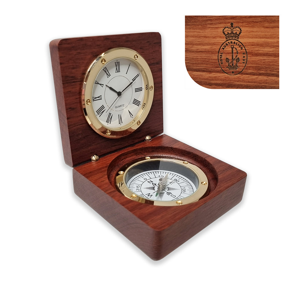 A wooden clock and compass desk set with the crest of the Royal Australian Navy, featuring brass hinges and a quartz clock mechanism.