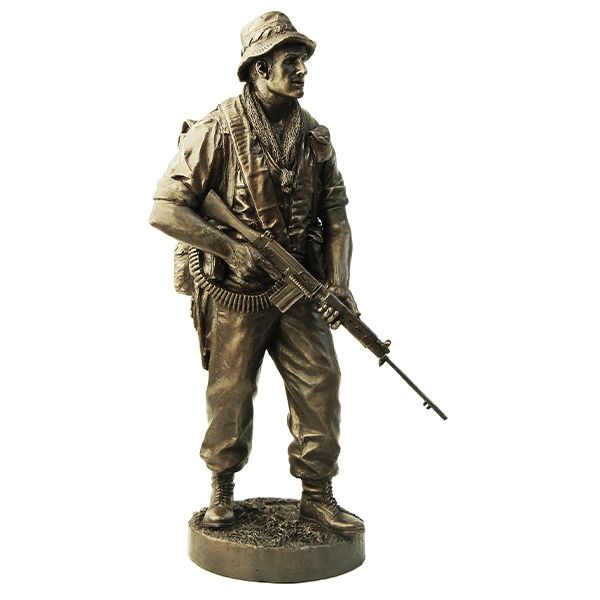 Bronze statue of a soldier holding a rifle on a white background