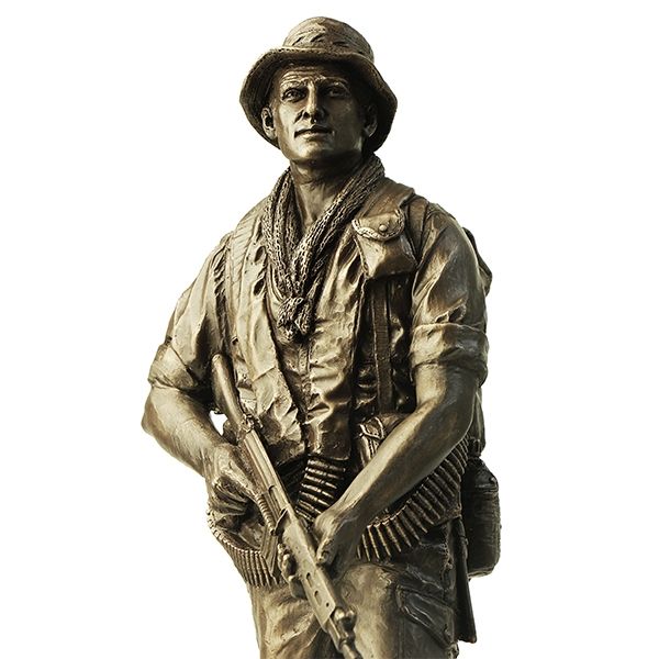 Bronze statue of a soldier holding a rifle on a white background