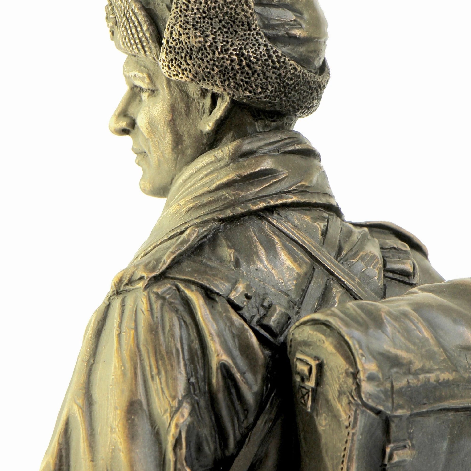 Bronze statue of a soldier with a helmet and backpack on a white background