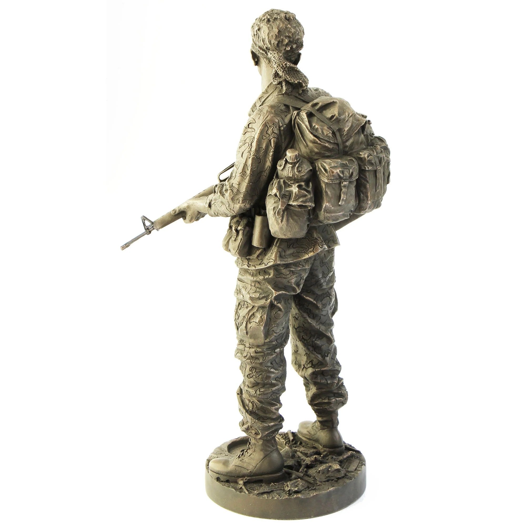Bronze statue of a soldier with a backpack and rifle on a white background