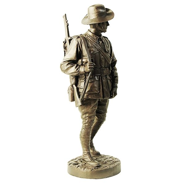 Bronze statue of a soldier with a rifle on a white background