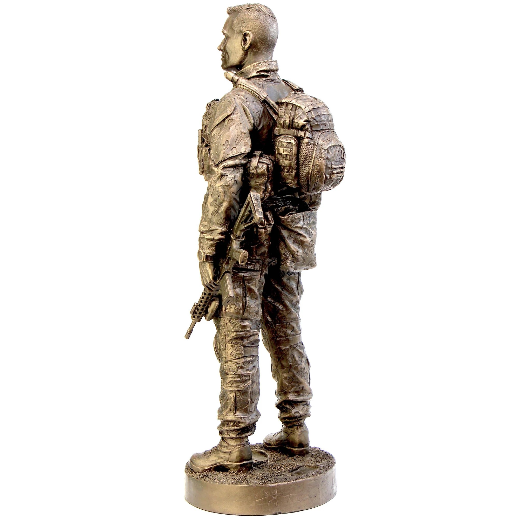 Bronze statue of a soldier with backpack and rifle on a white background